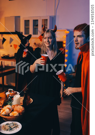 Friends enjoying a Halloween party at a bar making a toast Friends enjoying a Halloween party at a bar making a toast 134958505