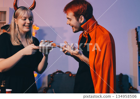 Friends enjoying a Halloween party at a bar making a toast 134958506