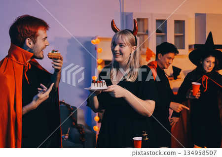 Friends enjoying a Halloween party at a bar making a toast Friends enjoying a Halloween party at a bar making a toast 134958507