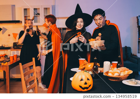 Friends enjoying a Halloween party at a bar making a toast 134958519