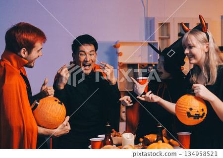 Friends enjoying a Halloween party at a bar making a toast Friends enjoying a Halloween party at a bar making a toast 134958521