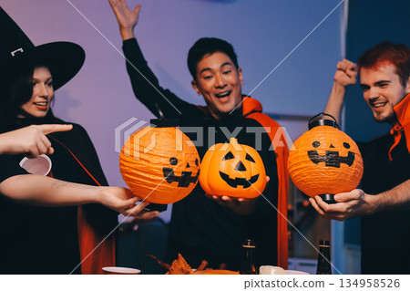 Friends enjoying a Halloween party at a bar making a toast 134958526