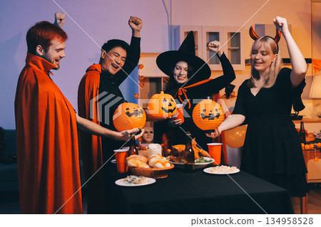 Friends enjoying a Halloween party at a bar making a toast Friends enjoying a Halloween party at a bar making a toast 134958528