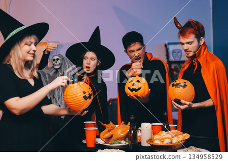 Friends enjoying a Halloween party at a bar making a toast 134958529