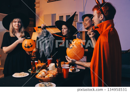 Friends enjoying a Halloween party at a bar making a toast Friends enjoying a Halloween party at a bar making a toast 134958531