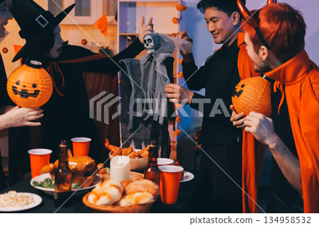 Friends enjoying a Halloween party at a bar making a toast 134958532