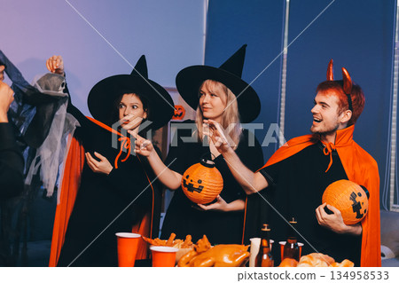 Friends enjoying a Halloween party at a bar making a toast Friends enjoying a Halloween party at a bar making a toast 134958533