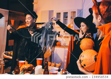 Friends enjoying a Halloween party at a bar making a toast 134958534
