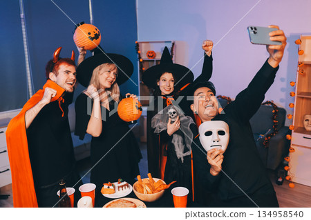 Friends enjoying a Halloween party at a bar making a toast Friends enjoying a Halloween party at a bar making a toast 134958540
