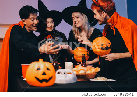 Friends enjoying a Halloween party at a bar making a toast Friends enjoying a Halloween party at a bar making a toast 134958541