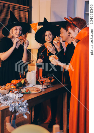 Friends enjoying a Halloween party at a bar making a toast 134958546