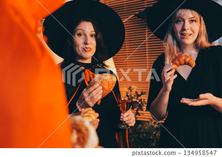 Friends enjoying a Halloween party at a bar making a toast 134958547