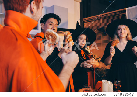 Friends enjoying a Halloween party at a bar making a toast 134958548