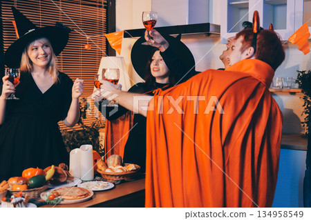 Friends enjoying a Halloween party at a bar making a toast 134958549