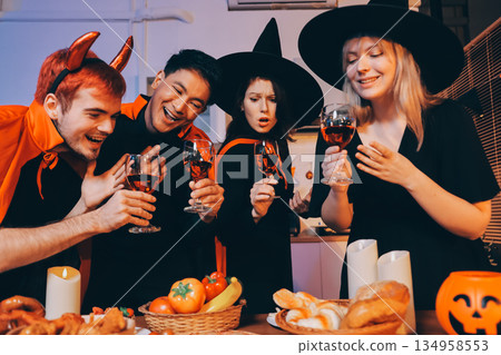 Friends enjoying a Halloween party at a bar making a toast 134958553