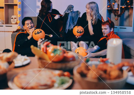 Friends enjoying a Halloween party at a bar making a toast 134958558