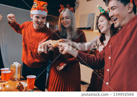 Festive Office Christmas Party with Delicious Food. A beautifully decorated office space with Christmas trees and festive lights, set up for a holiday party. 134958569