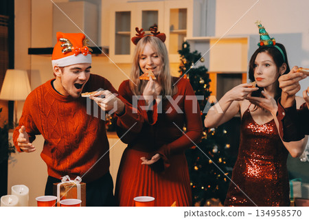 Festive Office Christmas Party with Delicious Food. A beautifully decorated office space with Christmas trees and festive lights, set up for a holiday party. 134958570