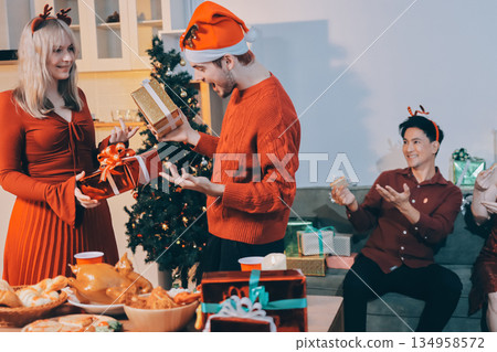 Festive Office Christmas Party with Delicious Food. A beautifully decorated office space with Christmas trees and festive lights, set up for a holiday party. 134958572