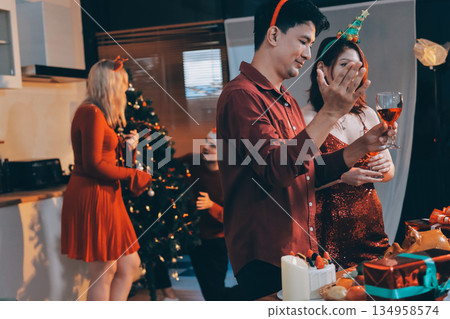 Festive Office Christmas Party with Delicious Food. A beautifully decorated office space with Christmas trees and festive lights, set up for a holiday party. 134958574