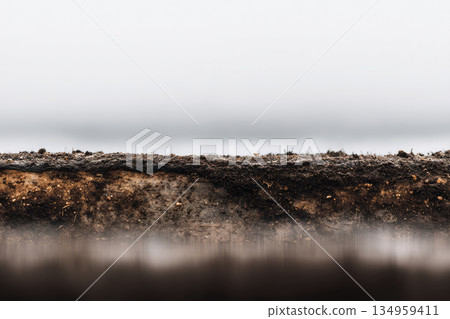 Soil cross section earth layer mud texture dirt ground nature agriculture close up brown horizontal outdoor moist organic environment geology rural farmland field natural sediment landscape 134959411