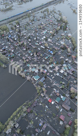 Aerial drone footage of a massive city flood with houses and streets submerged under water. Urban flooding caused by extreme weather and heavy rainfall, showing natural disaster impact on residential Aerial drone footage of a massive city flood with houses and streets submerged under water. Urban flooding caused by extreme weather and heavy rainfall, showing natural disaster impact on residential 134959680