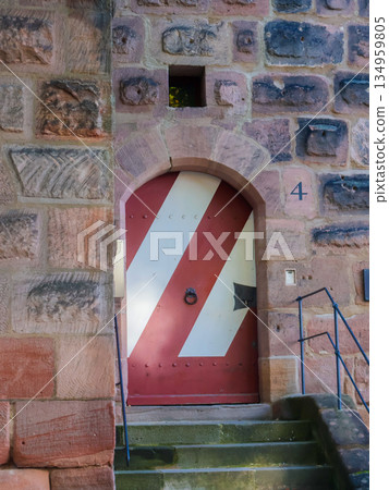 Arched Stone Doorway With Red And White Striped Door And Weathered Steps Old Building Entrance 134959805