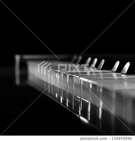 photo with the image of keyboard piano with transparent keys on a dark background 134959940