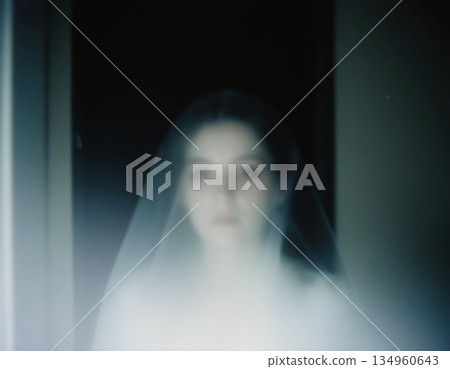 A spectral figure, shrouded in mist, appears in a shadowy corridor. The soft glow around the form adds to the eerie atmosphere of the haunting scene Generative AI 134960643