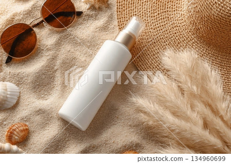 White blank spray bottle, rattan hat, pampas grass and seashells on a sandy beach, top view. Sunscreen cosmetics mockup. Summer vacation with spf uv-protected sunbathing White blank spray bottle, rattan hat, pampas grass and seashells on a sandy beach, top view. Sunscreen cosmetics mockup. Summer vacation with spf uv-protected sunbathing 134960699