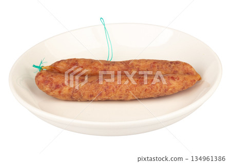 Thai pork sausage on a white plate against a white background Thai pork sausage on a white plate against a white background 134961386