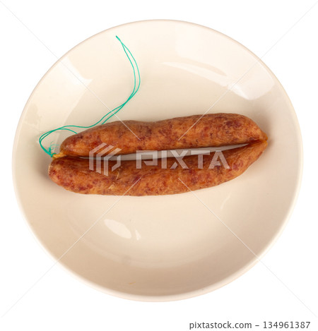 Thai pork sausage on a white plate against a white background Thai pork sausage on a white plate against a white background 134961387