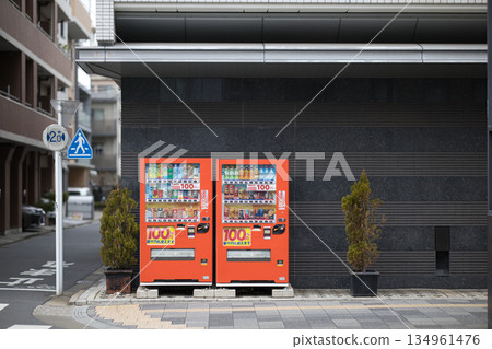 Two vending machines lined up on a city sidewalk 134961476