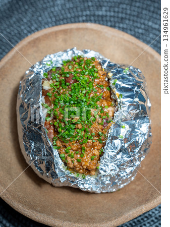 Baked Potato Topped With Seasoned Minced Meat 134961629
