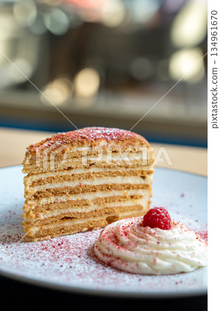 Layered Honey Cake with Raspberry Garnish 134961670