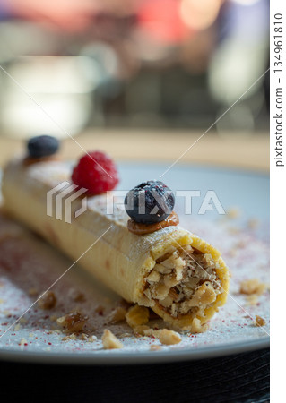 Rolled pancake with nuts and berries Rolled pancake with nuts and berries 134961810