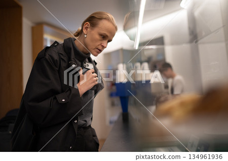 Woman looking at pastry display 134961936