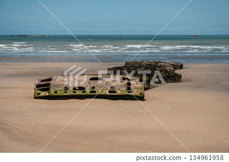 Visible remains of the Mulberry Harbour platforms on the beach of Arromanches-les-Bains, France. These massive concrete structures were used during the D-Day landings in World War II. 134961958