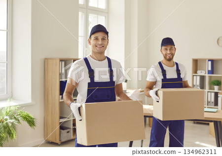 Smiling Movers with Cardboard Boxes during Relocation 134962311