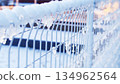 Snowy and frozen fence 134962564