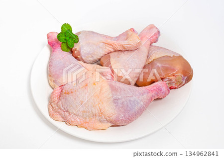 Uncooked bone-in chicken on a plate Uncooked bone-in chicken on a plate 134962841