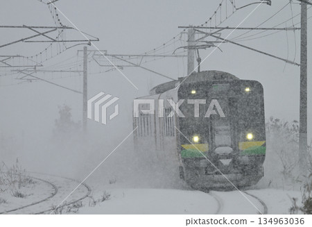 A local train running through a snowstorm A local train running through a snowstorm 134963036