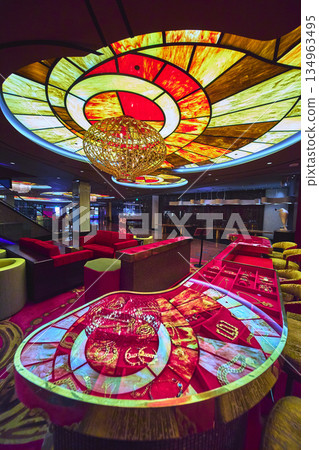 Las Vegas Casino Interior Vibrant Stained Glass Ceiling Modern Chandelier and Gaming Table Las Vegas Casino Interior Vibrant Stained Glass Ceiling Modern Chandelier and Gaming Table 134963495