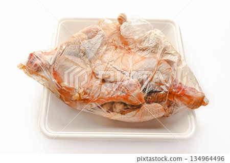Bone-in chicken marinated in a plastic bag Bone-in chicken marinated in a plastic bag 134964496