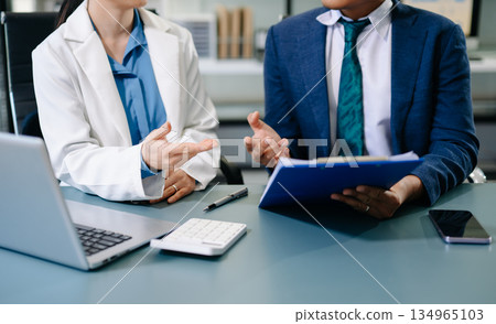 Team business meeting presentation. Hand businessman working project in modern office.Laptop computer and tablet and smart phone on white desk Team business meeting presentation. Hand businessman working project in modern office.Laptop computer and tablet and smart phone on white desk 134965103