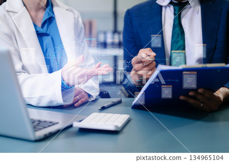 Business professionals using smartphone and holographic AI data interface to analyze digital information and innovate in office. 134965104