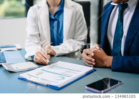 Team business meeting presentation. Hand businessman working project in modern office.Laptop computer and tablet and smart phone on white desk Team business meeting presentation. Hand businessman working project in modern office.Laptop computer and tablet and smart phone on white desk 134965105