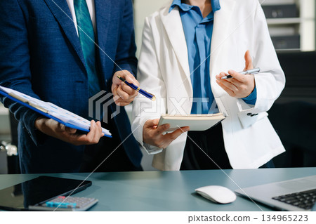 Team work process. Photo young business crew working with new startup project. Project managers meeting. Analyze plans, papers. 134965223