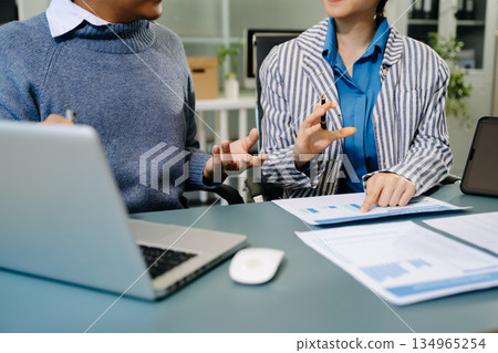 Team work process. Photo young business crew working with new startup project. Project managers meeting. Analyze plans, papers. At office Team work process. Photo young business crew working with new startup project. Project managers meeting. Analyze plans, papers. At office 134965254