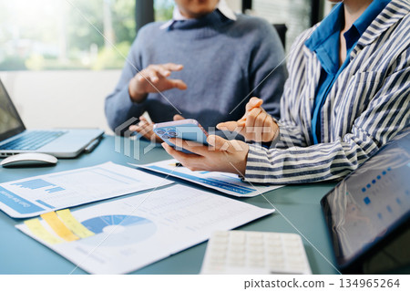 Team business meeting presentation. Hand businessman working project in modern office.Laptop computer and tablet and smart phone on white desk Team business meeting presentation. Hand businessman working project in modern office.Laptop computer and tablet and smart phone on white desk 134965264